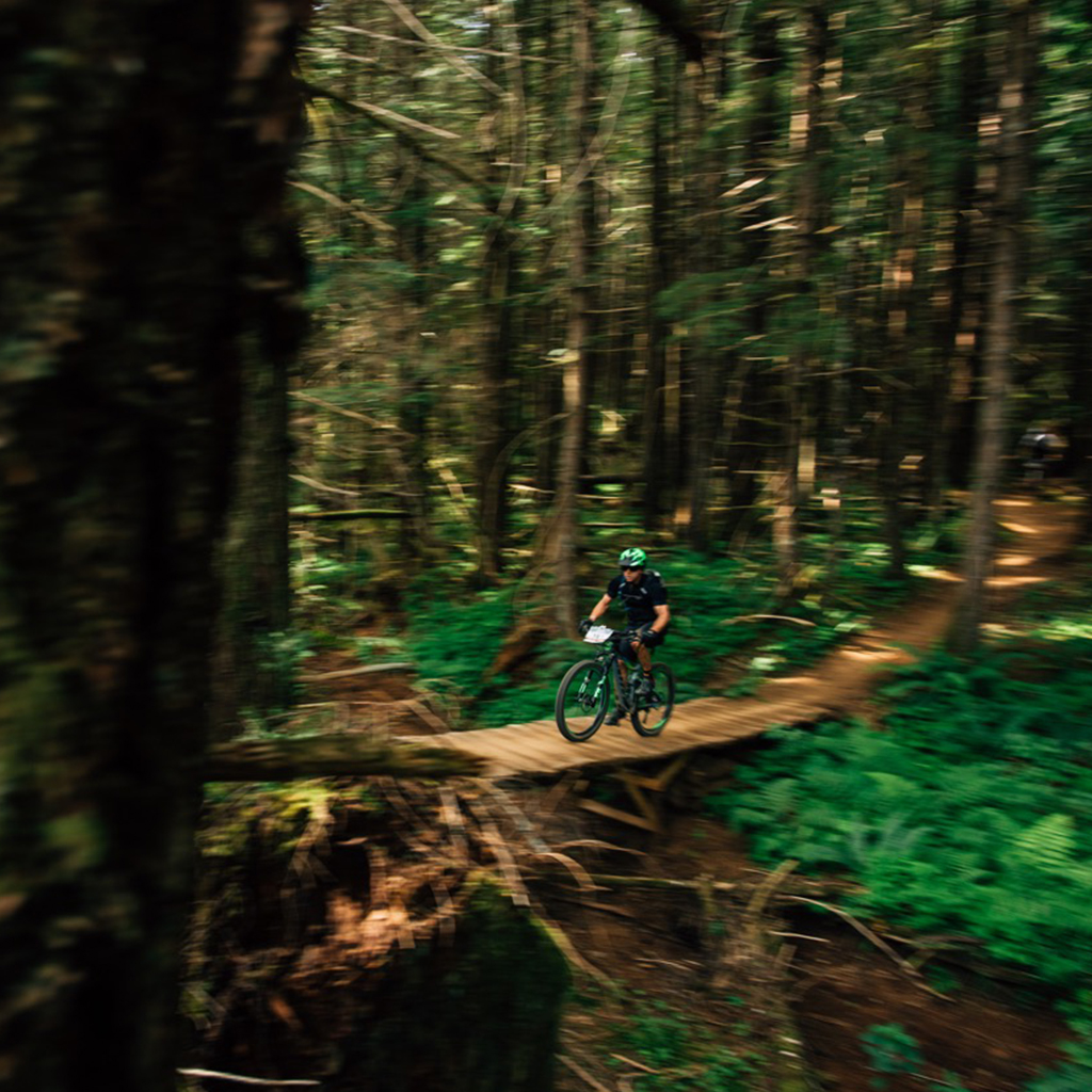 Endurance cyclist on a mountain trail at sunrise